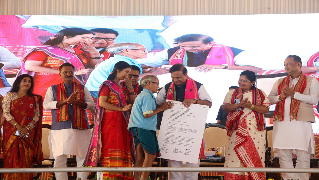 Assam CM distributes cheques under Zero Cost Employee Insurance Scheme