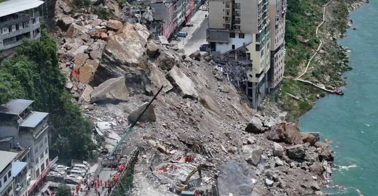 A huge landslide in southwest China buries homes and force more than 1,000 to evacuate