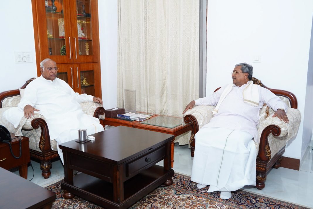PTI file photo of Mallikarjun Kharge and Siddaramaiah seated during a meeting