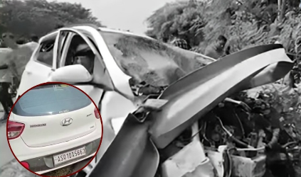 A damaged white car after a collision with a highway guardrail